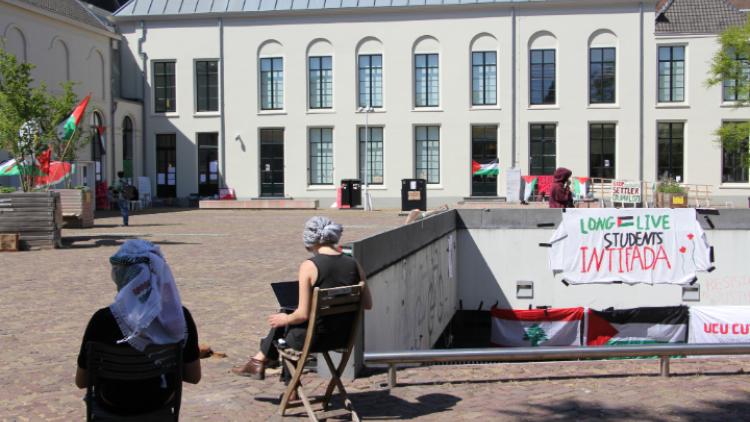 Students at the City Library Encampment sitting and working.