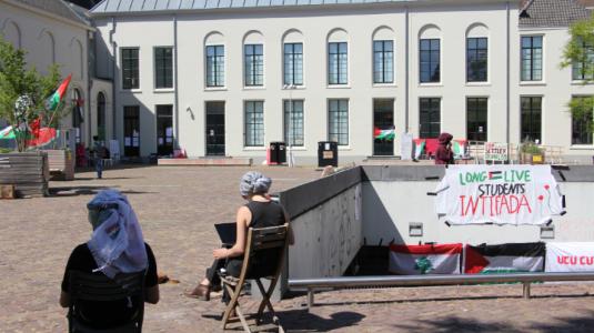 Students at the City Library Encampment sitting and working.